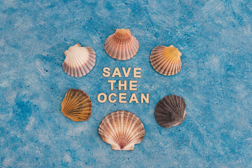 save the ocean text on blue bakground with sea shells, act for climate change concept