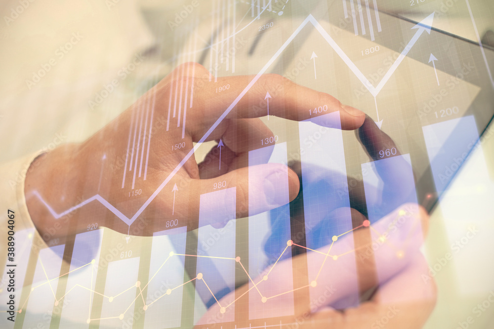 Poster multi exposure of man's hands holding and using a phone and financial chart drawing. market analysis
