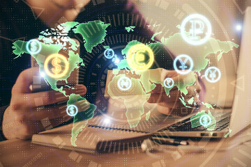 Double exposure of man's hands holding and using a phone and financial graph drawing. Analysis...