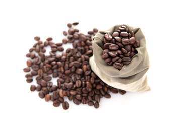 Looking down on a bag of coffee beans and scattered coffee beans on white background