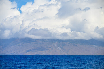 Clouds over wind turbines in Maui, Hawaii.