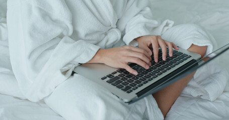 Woman work on laptop computer at hotel room at quarantine period