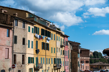 Fototapeta na wymiar Green windows in the heart of Siena, Italy.