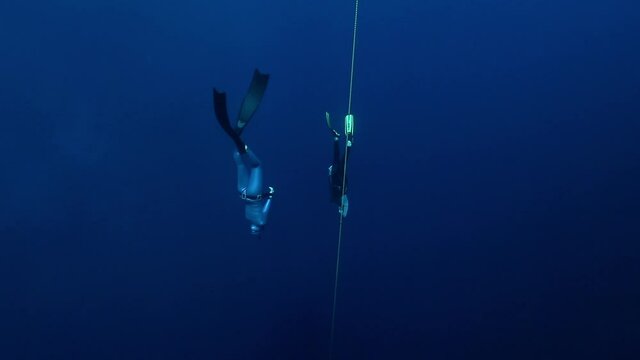 Freedivers work out along the rope and descend. Freediving in the famous Blue Hole in the Red Sea in Egypt