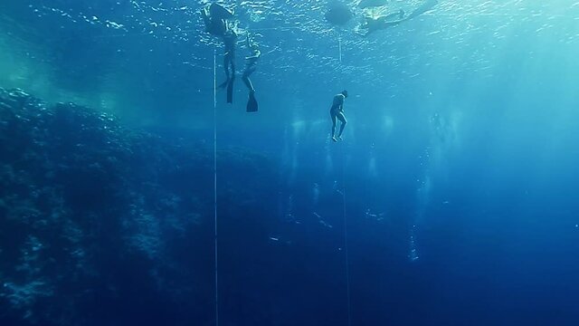 Professional freediver ascends along the rope in the famous Blue Hole in the Red Sea in Egypt