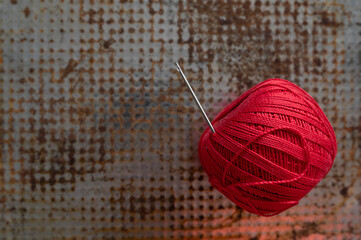 Spool of red thread and needle