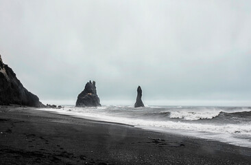Naklejka na ściany i meble Icelandic black beach landmark rock