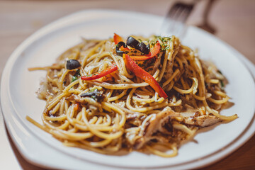 Healthy vegan spaghetti with zucchini, tomatoes and nuts