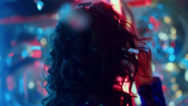 Charming girl biting lip at party. Pretty female person flirting in nightclub