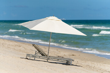 Photo of umbrella and beach chair no people in scene