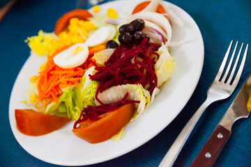 Mix salad with vegetables, prune, boiled beet and lettuce, nobody