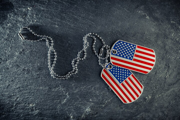 US military dog tags in the shape of the American flag. Memorial Day for Veterans Day concept.
