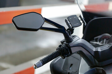 Motorcycle mirror and handlebar detail. Motorcycle handlebar with button control. Selective focus. Copy space for any design. 