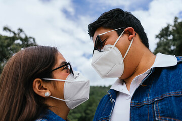 man and woman with masks and glasses staring at each other