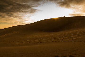 Climbers Watching Sunset on The Dune Field of Great Sand Dunes National Park, Colorado, USA