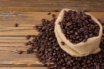 The aroma of roasted coffee beans are placed in a bag placed on an old wooden floor.