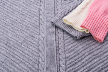 Textured sweater knitting yarn gray pink white - abstract background image.