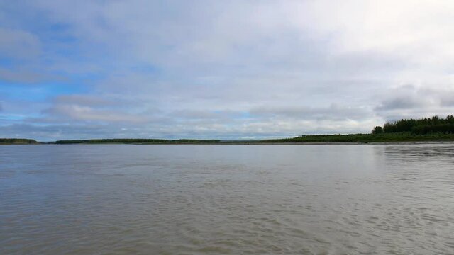 Lake panorama shot from motorboat, distant lakeshore