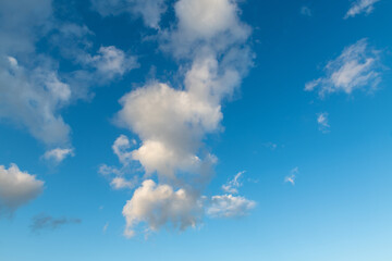 Naklejka na ściany i meble White clouds close-up in the blue sky