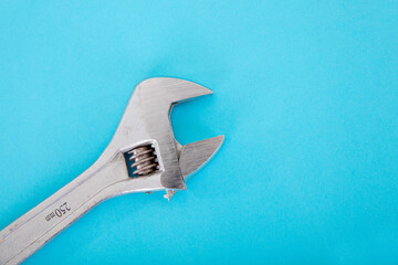 A pair of metal pliers on a blue background