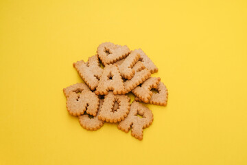 cracker biscuits alphabet symbols or cookie with yellow background