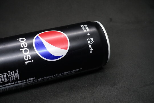 A can of pepsi black against isolated black background