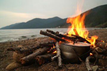 Tourist's evening. Pot on the fire bonfire