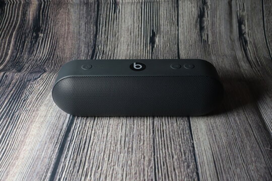 Beats Pill wireless speaker against wooden background