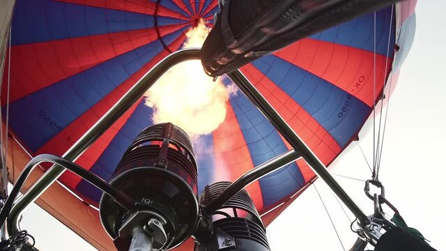 Burner and flames of hot air balloon, low angle slow motion view