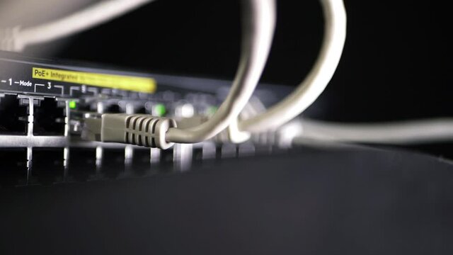 Network switch with ethernet utp cables close up panning shot