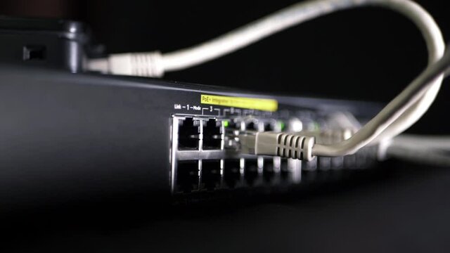Network switch with Ethernet utp cables panning shot