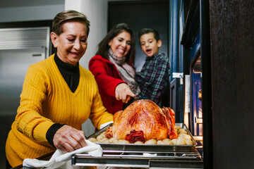 Mexican family cooking Christmas turkey on the oven