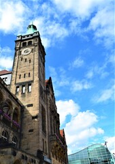 Fototapeta na wymiar Chemnitz city center during sunny day. Chemnitz town-hall building and clock tower with blue sky and white cloud.