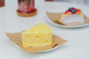 Cute yellow jerry chessecake butter shape korea style on white table with snack.