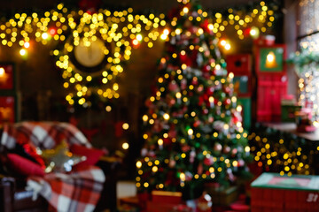 A blurry view of a stylish Christmas room interior in a dark room with garland lights.