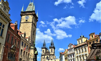 Obraz premium Prague and Czech Republic during sunny day. Top of the ancient buildings in Prague together with blue sky and white cloud background.