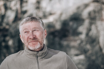 Portrait of an unshaven attractive and happy middle-aged man outdoors. People and lifestyle...