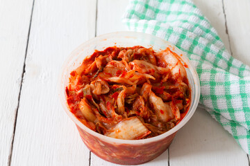 Close-up shot Korean traditional food called 'Kimchi or Kimchee' in plastic container. Vegetable pickle