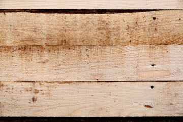 Horizontally laid unplaned pine board for rough work. Natural wooden rough background.