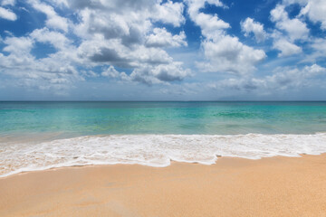 Tropical paradise beach with warm sand and turquoise sea wave in paradise island. Tropical beach background.