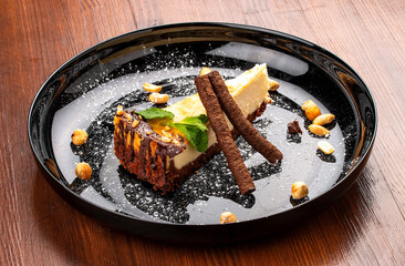 Cheesecake with nuts and chocolate tubes. On a decorative plate