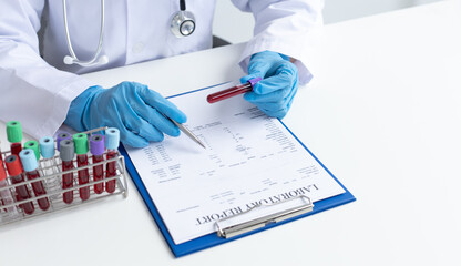 Fototapeta premium Scientists or physicians analyze the blood sample in vitro to prepare a vaccine against a new strain of viruses.