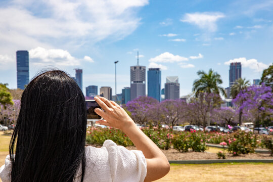 woman taking a picture of the city