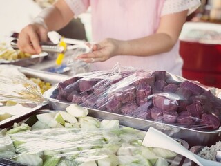 Blurred image of people shopping in supermarket. Cashier with long line of people waiting at checkout counter in fitness store at outlet shopping mall in Thailand.