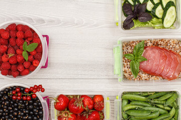 Plastic meal prep containers with meat, vegetables and berries