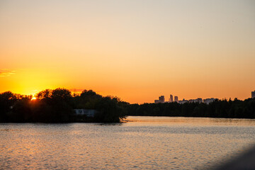 Fototapeta premium sunset on the horizon from the motor ship city river
