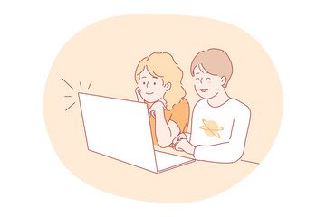 Online education, technology, communication concept. Happy captivated boy girl brother sister sitting together and studying remotely at laptop. Wireless learning communication and digital technologies