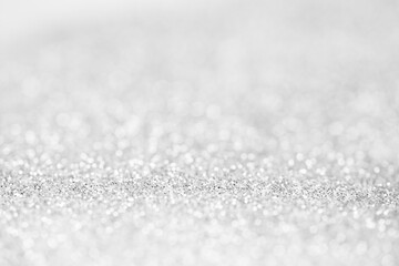 blurred abstract sparkling silver bokeh background. festive decoration for website banner and card concept. soft focus