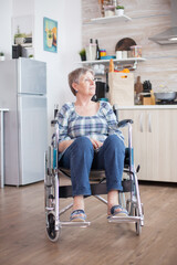 Sad depressed disabled senior woman sitting in a wheelchair. Elderly handicapped pensioner after...