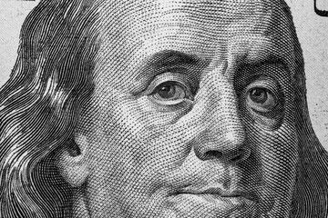 United States hundred dollars money bill closeup. Portrait of US president Benjamin Franklin on 100...